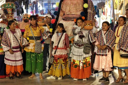 Free A group of women in traditional clothing participates in a festive parade, showcasing cultural heritage. Stock Photo