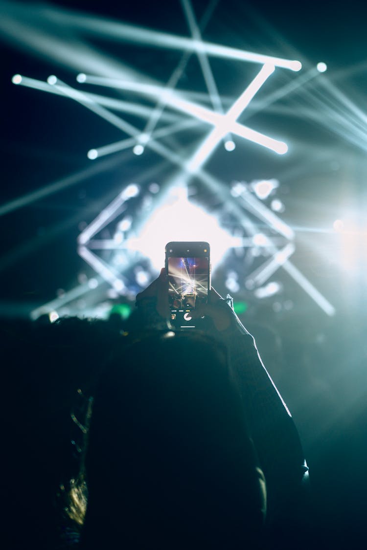 Woman Taking Pictures At Concert