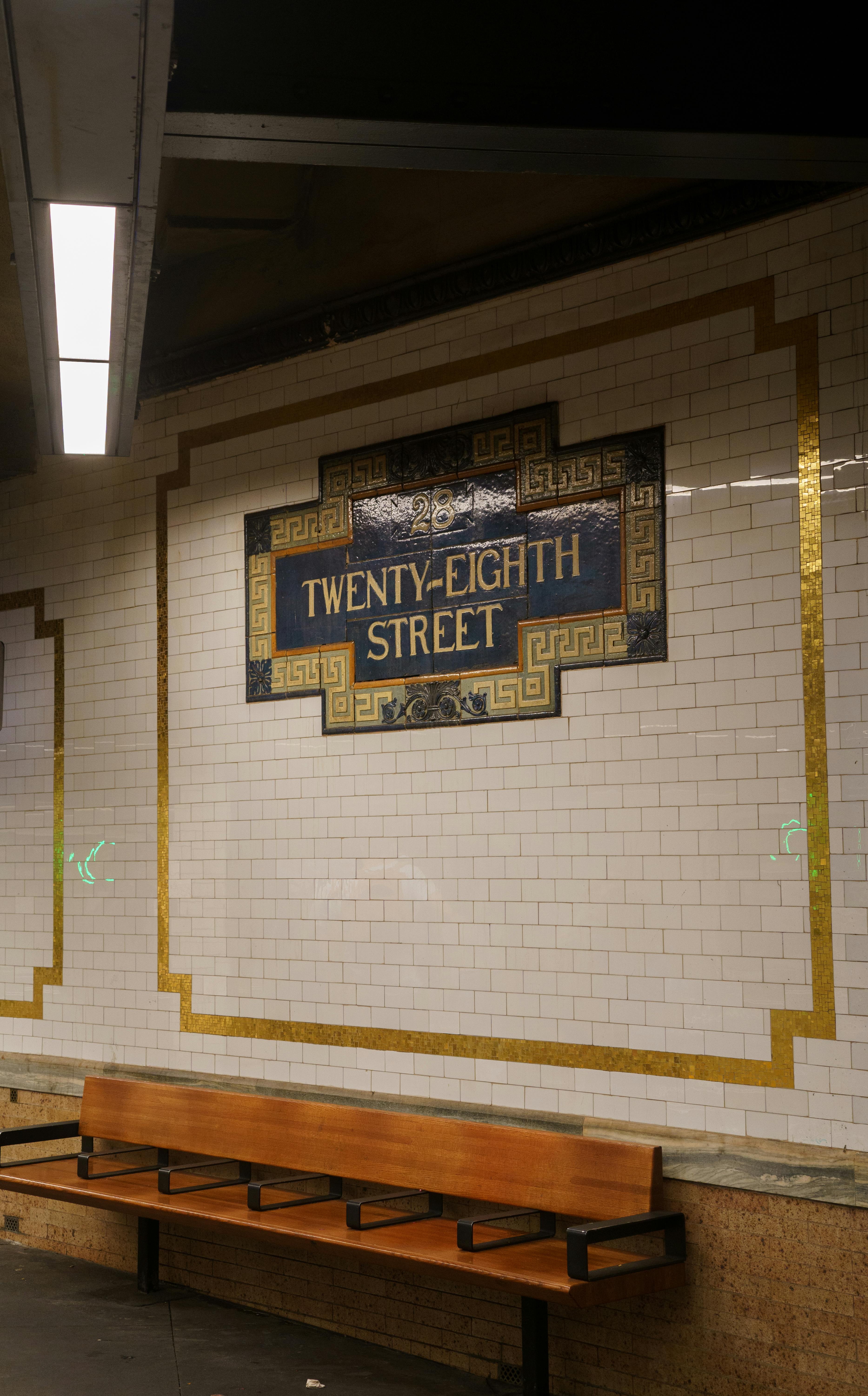 twenty eight street board on wall in subway in new york