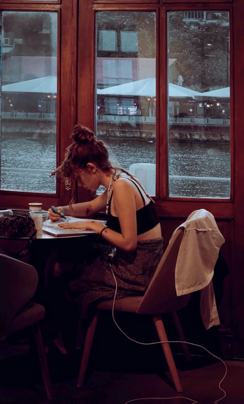 Young Woman Studying in Cafe