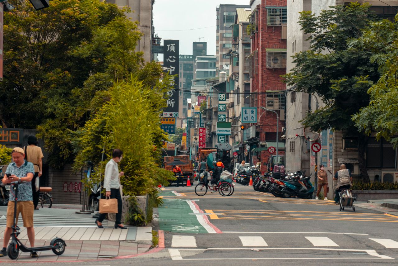 bustling city street with people cyclists scooters and vibrant urban e