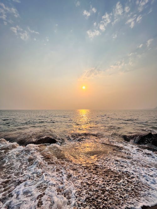 Free A Sunrise Over the Rough Sea Stock Photo