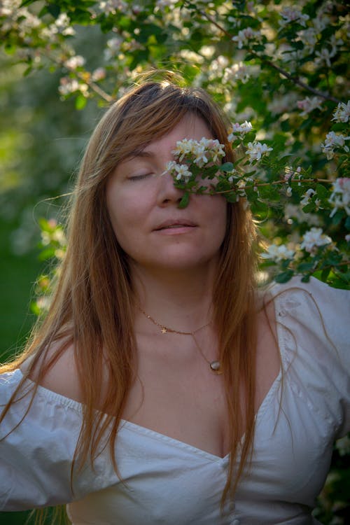Spring Blossoms over Woman with Eyes Closed