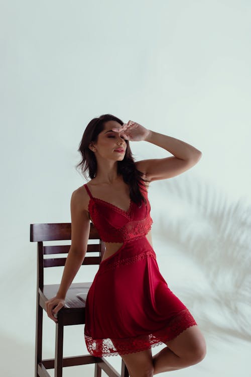Woman in Red Dress Posing by Chair