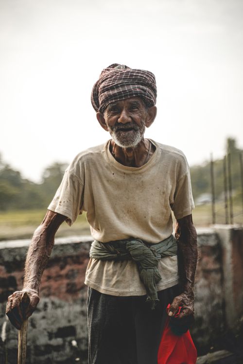 Free A senior man with a traditional hat poses outdoors, showcasing cultural attire. Stock Photo