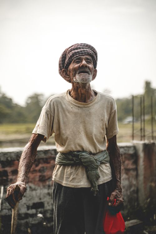 Free Portrait of a senior man with a turban standing outdoors during the day. Stock Photo