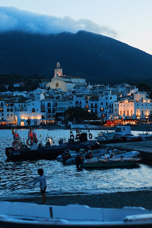 A boat is docked in front of a mountain