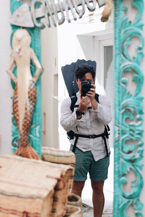 A man taking a selfie in front of a mirror