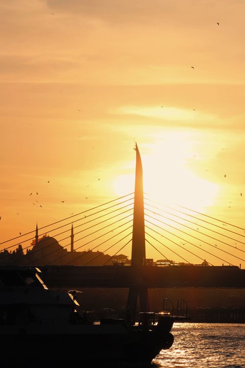Free Silhouette of the Golden Horn Bridge against a vibrant sunset in Istanbul, Turkey. Stock Photo