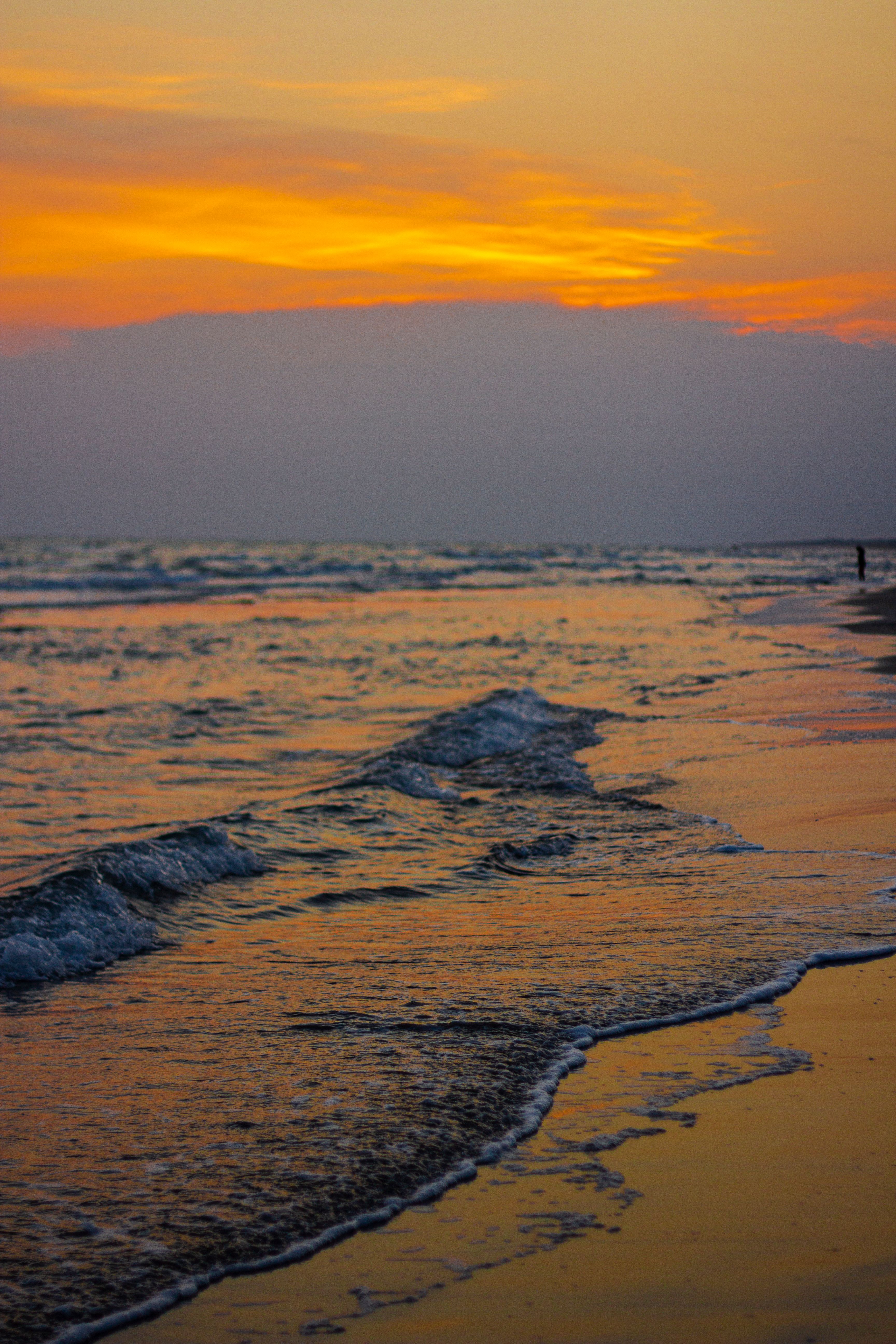 Girl Wearing Blue Dress Standing in the Sea at Dusk · Free Stock Photo