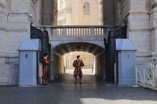 Swiss Guards standing at the Vatican City's entrance gate, Rome, Italy.