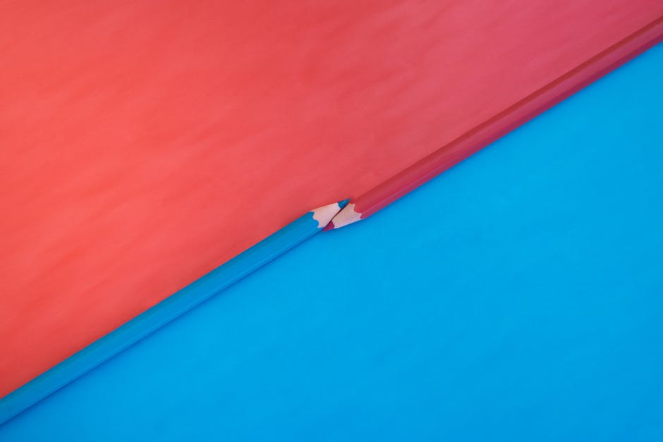 Abstract composition featuring red and blue pencils on contrasting red and blue backgrounds.