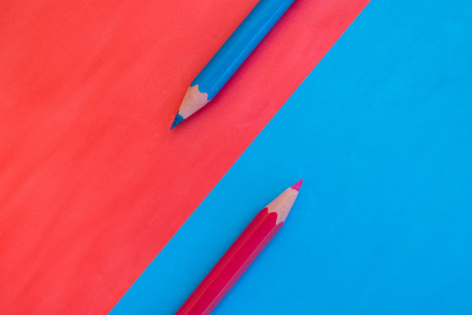 A vibrant and minimalistic composition with red and blue pencils on contrasting backgrounds.