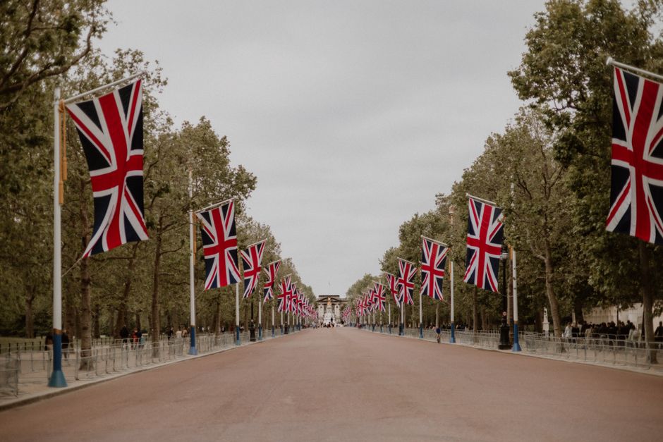 Union Jack flags line The Mall in London, leading to Buckingham Palace.
