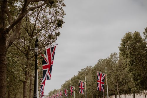Free Union Jack flags adorn The Mall in London, emphasizing British heritage. Stock Photo