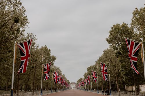 Free Scenic view of The Mall in London adorned with Union Flags, leading to Buckingham Palace. Stock Photo