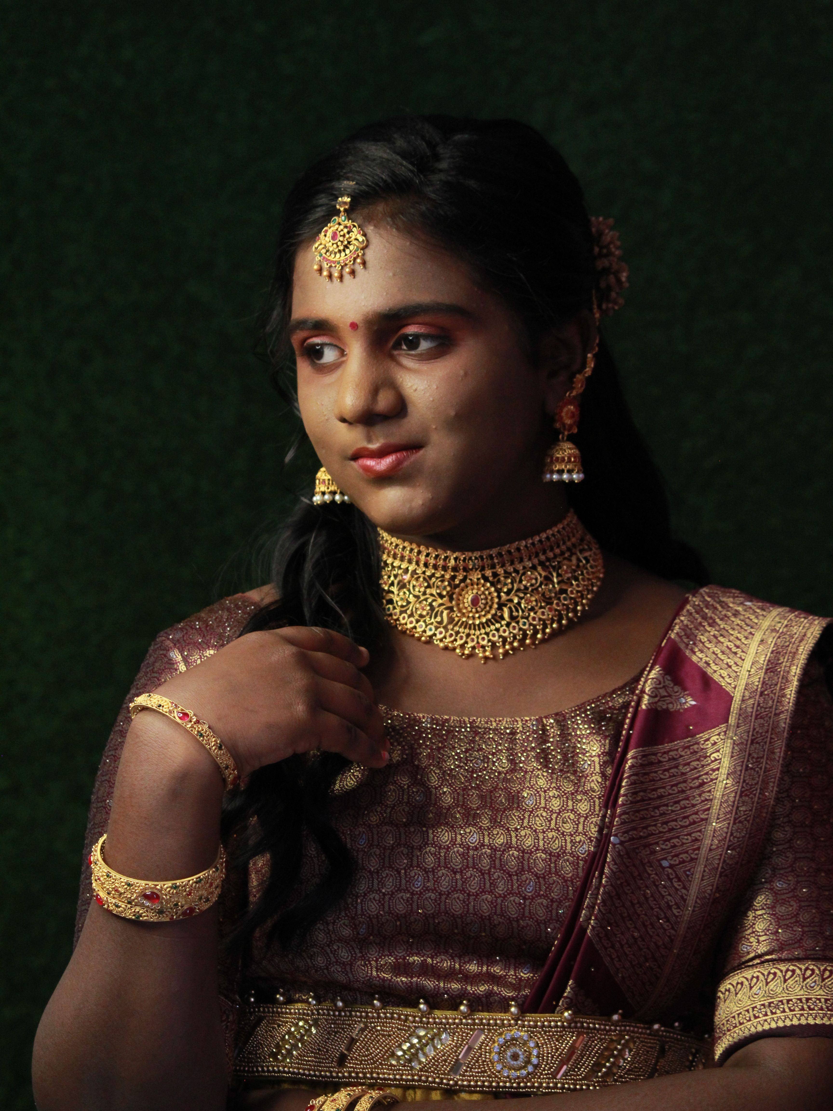 Captivating portrait of an Indian woman adorned in traditional jewelry and attire, showcasing cultural beauty.