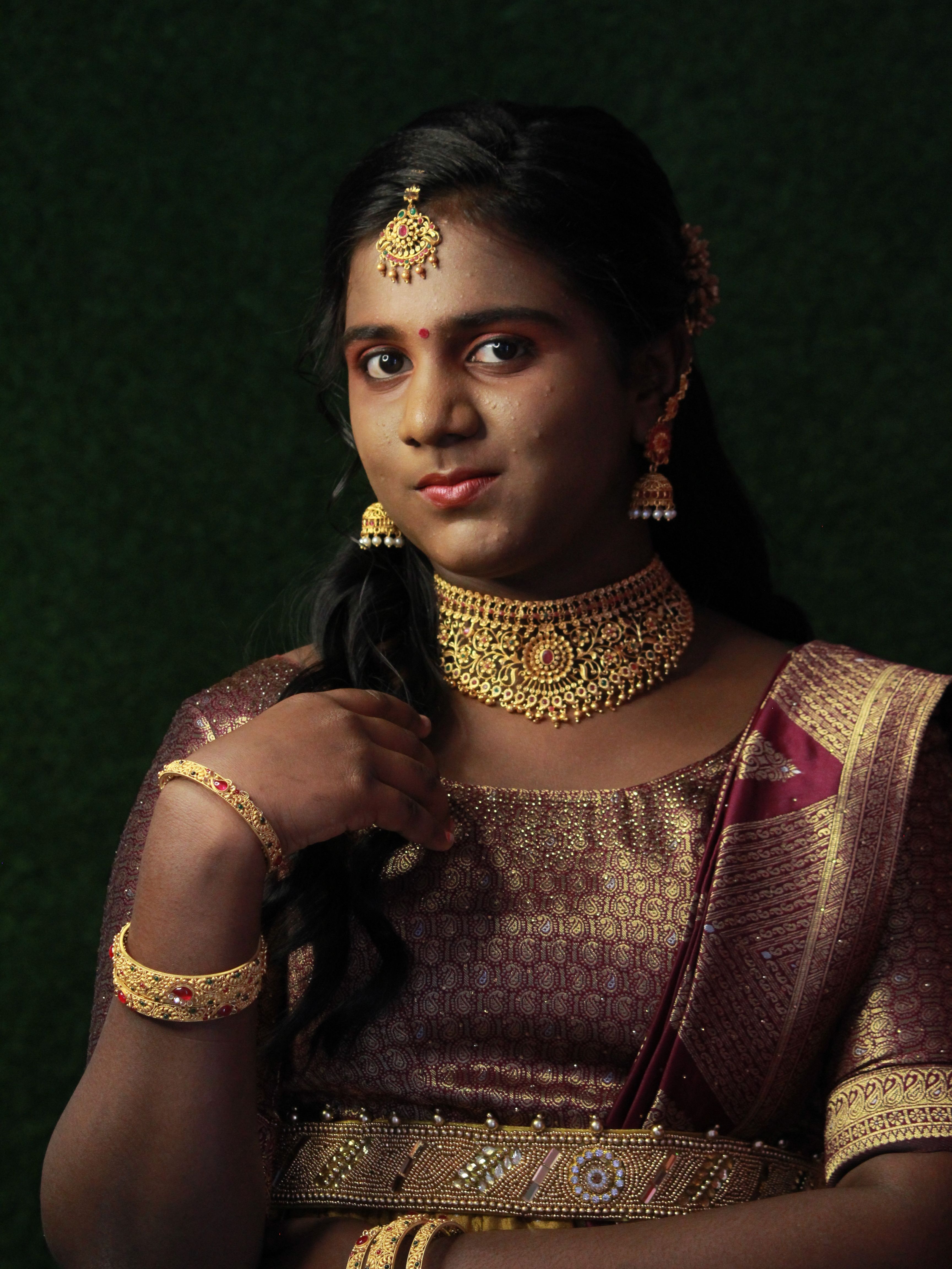 Stunning portrait of a woman in traditional attire, showcasing exquisite jewelry and cultural beauty.