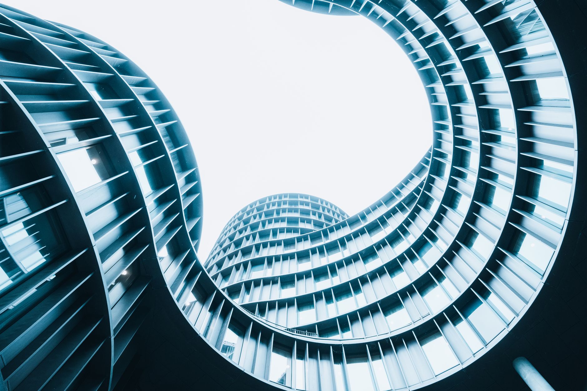 A striking low-angle shot of a modern spiral designed building showcasing urban architectural innovation.