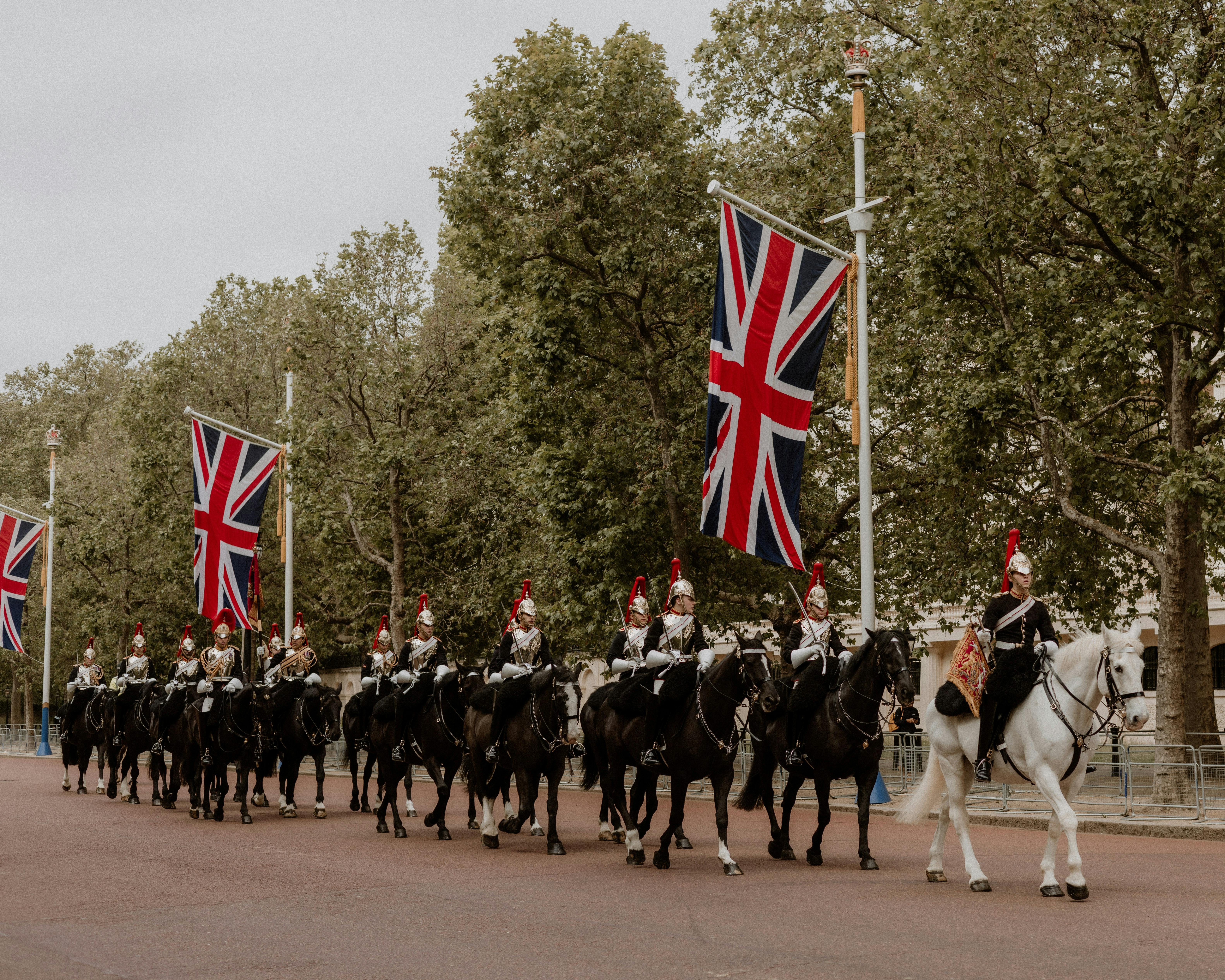 a group of horses and riders with british flags