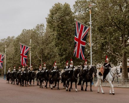 A group of horses and riders with british flags