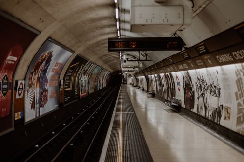 Free Empty London Underground tube station platform with signs and advertisements. Stock Photo