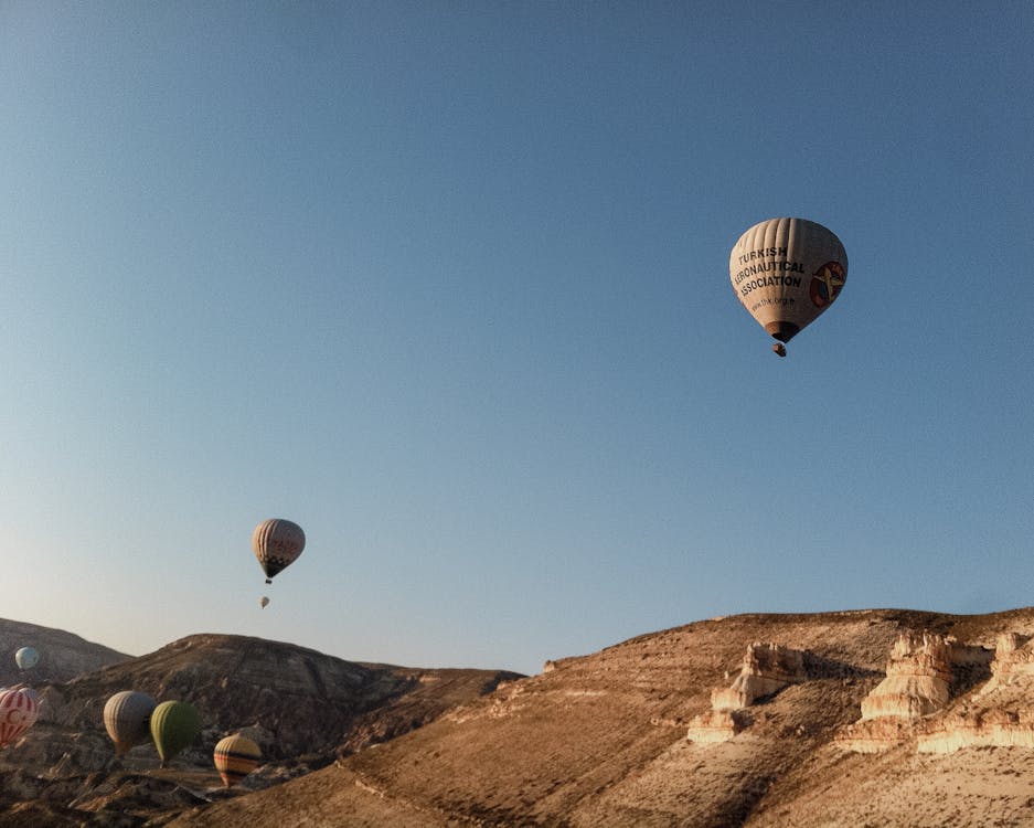 Hot Air Balloons Above Mountains