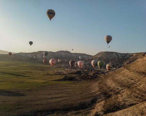 Hot Air Balloons Flying over the Hills in Cappadocia, Turkey 