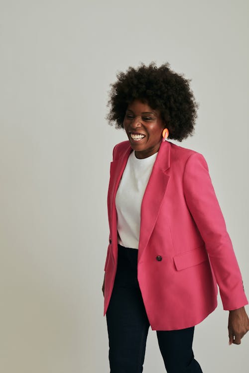 Smiling Woman in Pink Suit