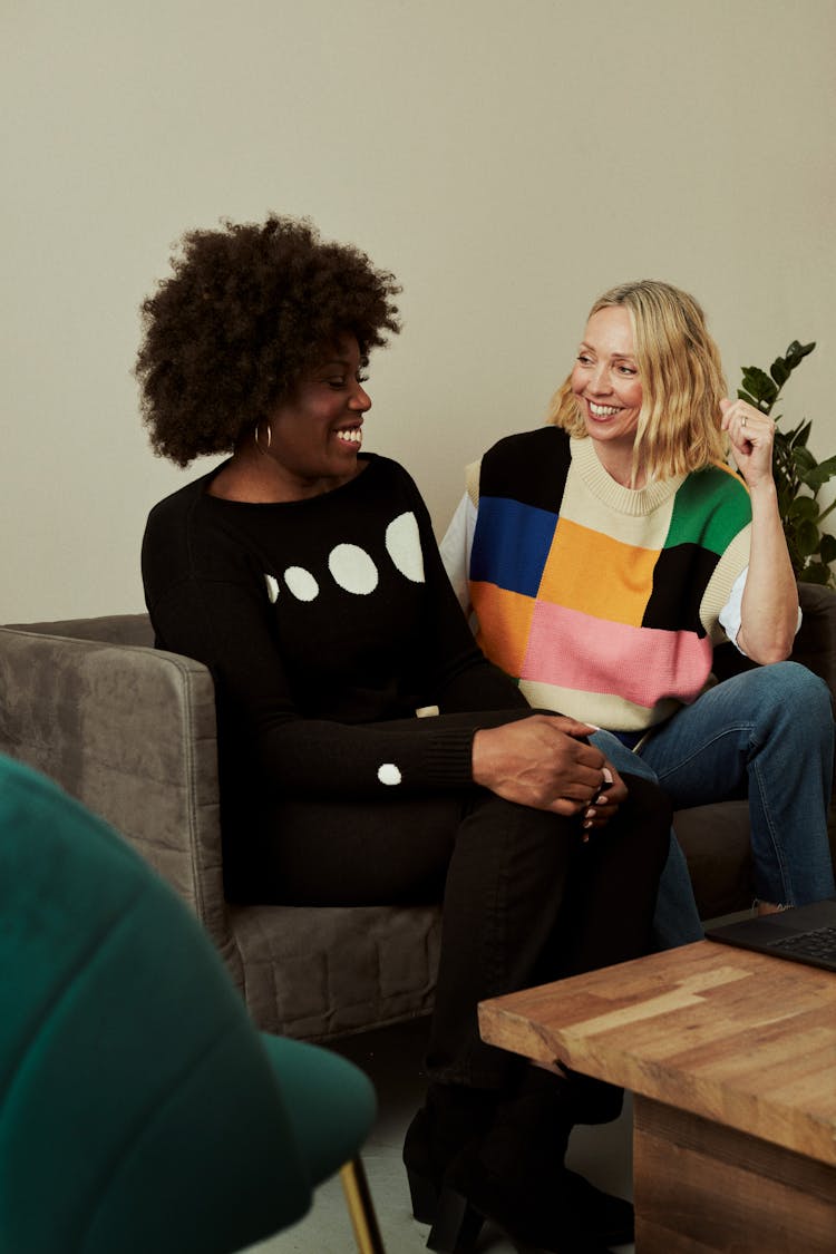 Smiling Woman Sitting On Sofa