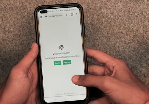 Webpage of ChatGPT, a prototype AI chatbot, is seen on the website of OpenAI, on a smartphone. Examples, capabilities, and limitations are shown.