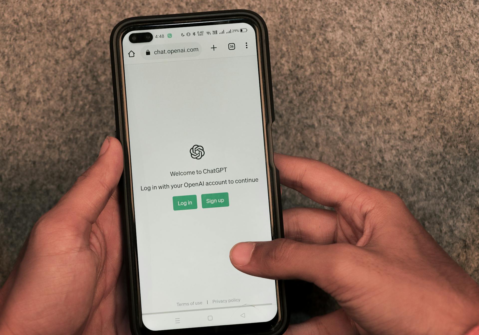 Webpage of ChatGPT, a prototype AI chatbot, is seen on the website of OpenAI, on a smartphone. Examples, capabilities, and limitations are shown.