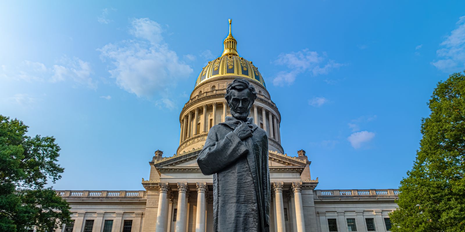 The facade of the West Virginia State Capitol under a clear blue sky