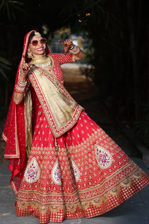 A Bride in a Traditional Outfit Posing Outside 