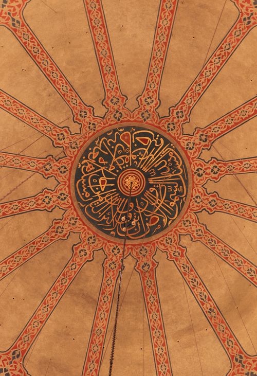 Free Beautiful detailed ceiling mosaic design in a mosque interior with Arabic calligraphy. Stock Photo