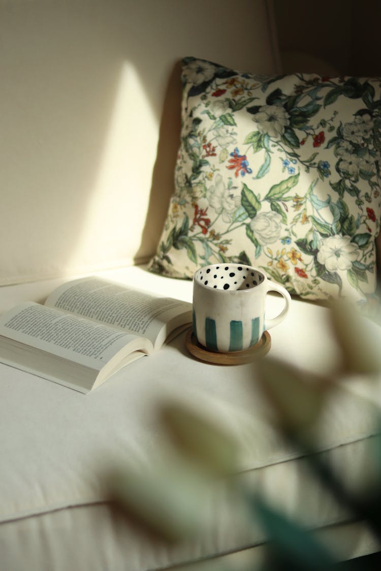 Cup And Book On Couch