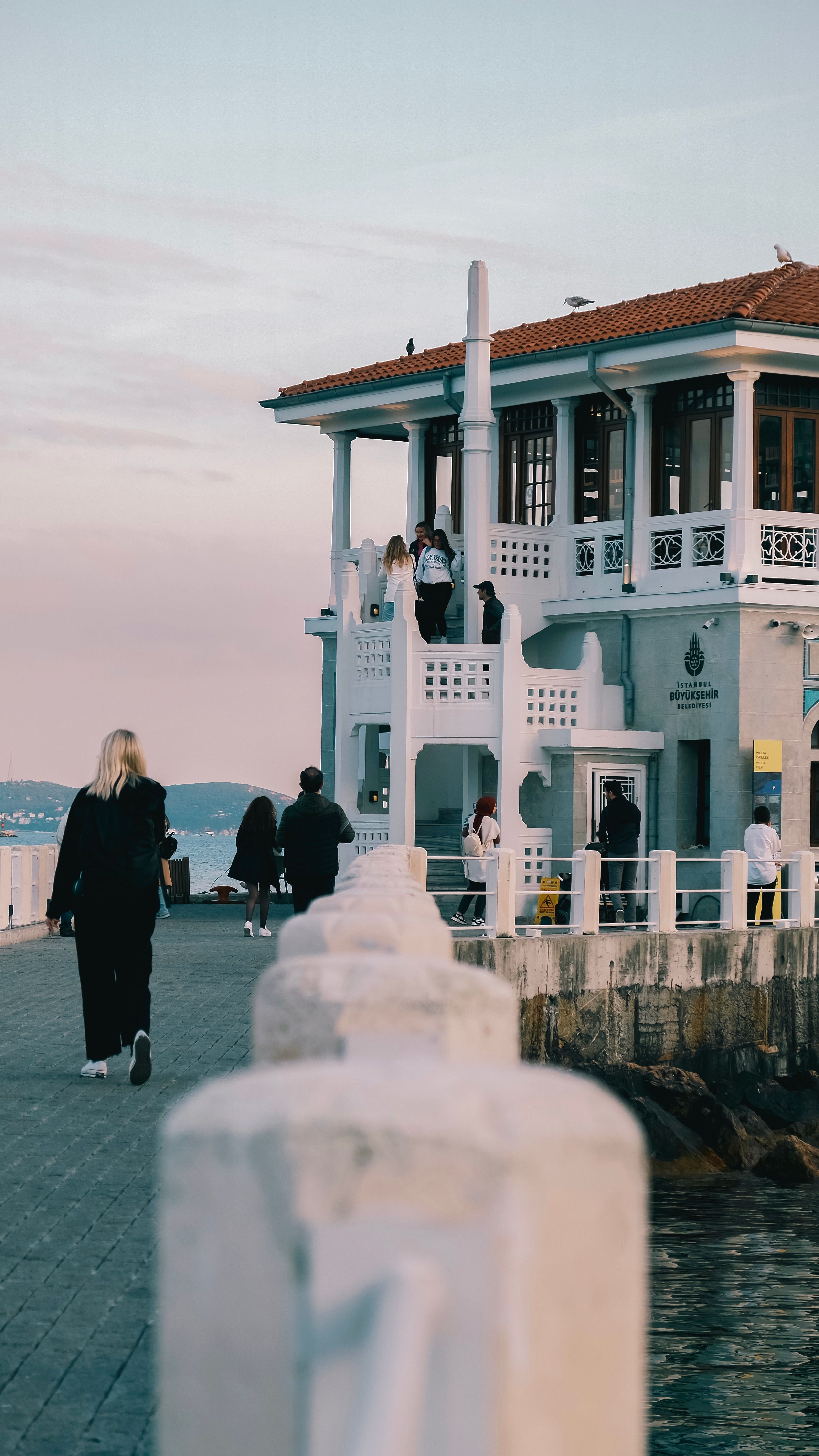 Passengers enjoying the view at Kadikoy Ferry Terminal, Istanbul during sunset.