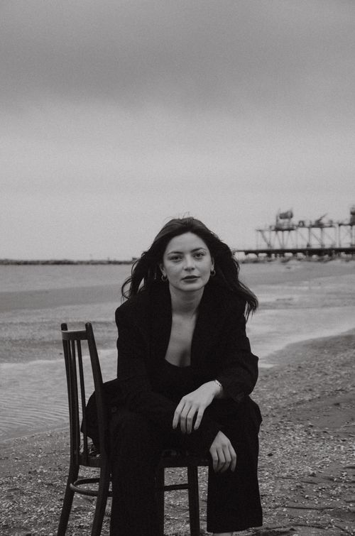 Free Chic monochrome portrait of well-dressed woman by the seashore. Stock Photo
