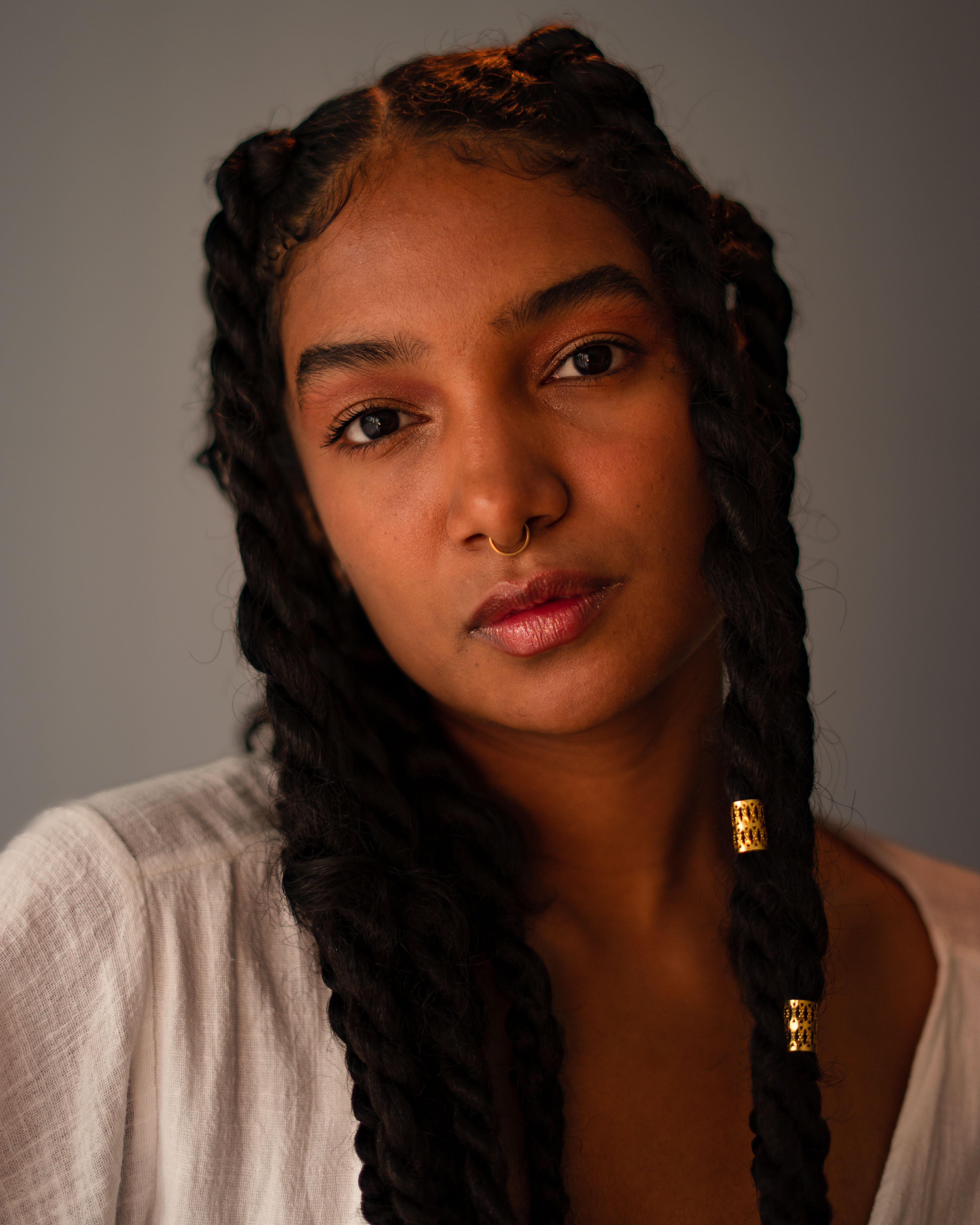 Close-up Portrait of a Young Woman with Braided Hair · Free Stock Photo
