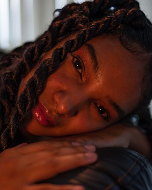 Free Intimate close-up portrait of a woman with dreadlocks and a serene expression. Stock Photo