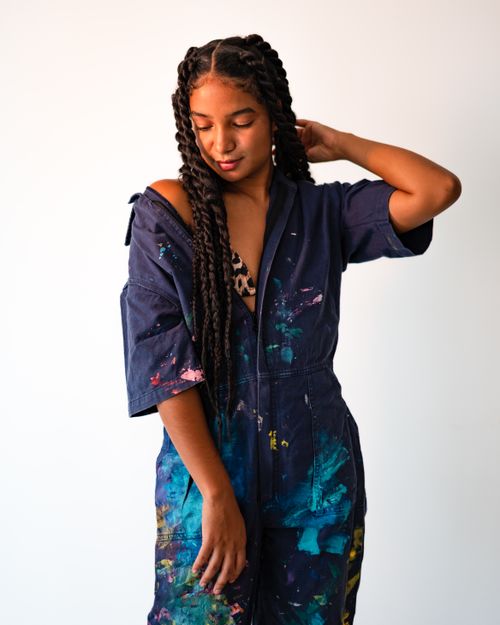 Free Artistic portrait of a woman with dreadlocks wearing painted coveralls. Stock Photo