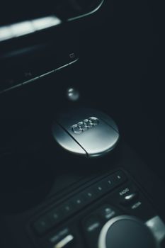 Detailed view of an Audi car interior focusing on the logo and gear shift.