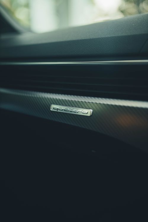 Free Detailed view of a car interior featuring the quattro emblem on the dashboard. Stock Photo