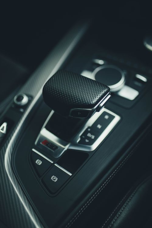 Free Close-up shot of a luxury car's gear shift with modern design elements. Stock Photo