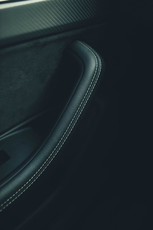 Free Close-up of a luxury car's leather interior handle, emphasizing sleek design and premium materials. Stock Photo