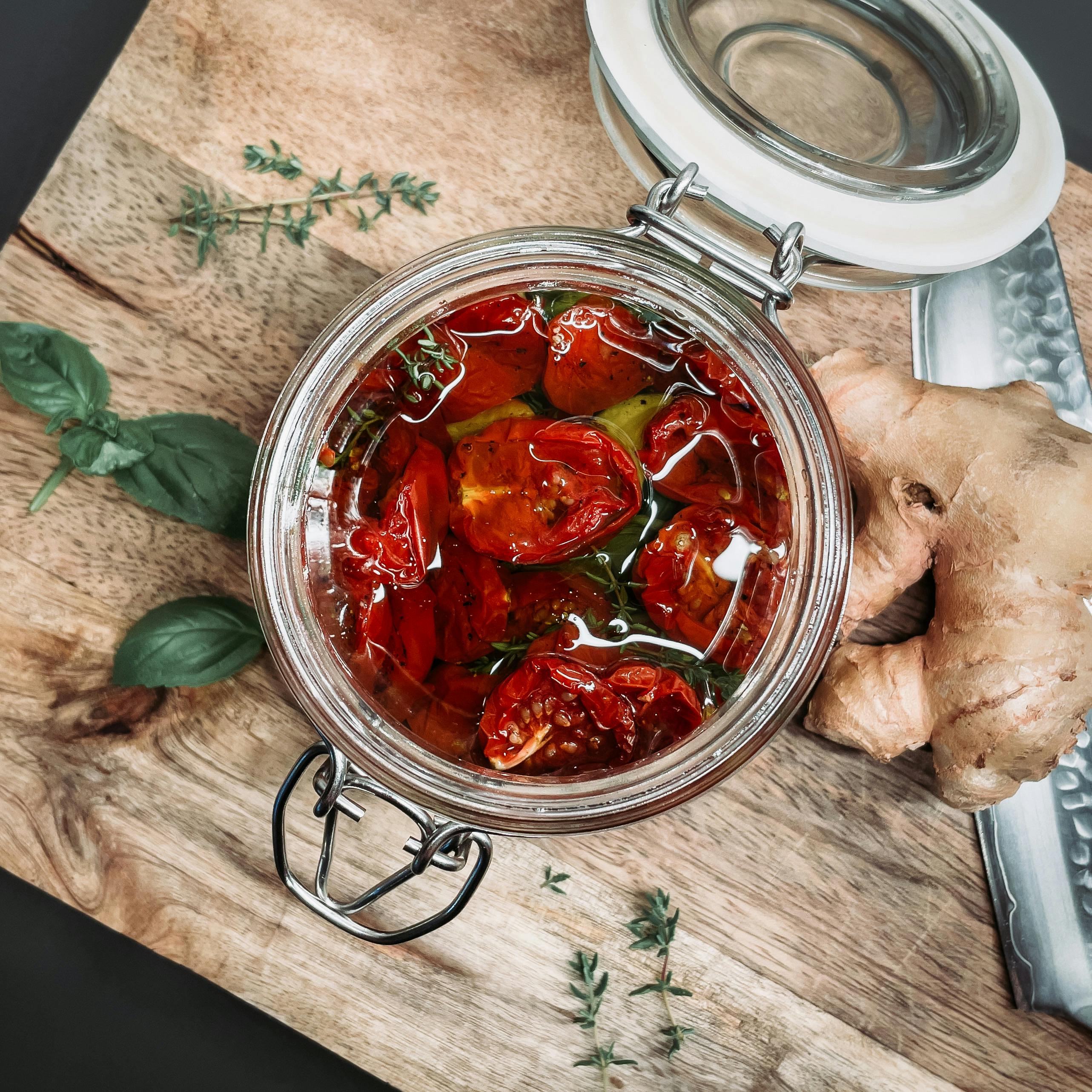 A jar of homemade sunshine pickles with fresh cucumbers