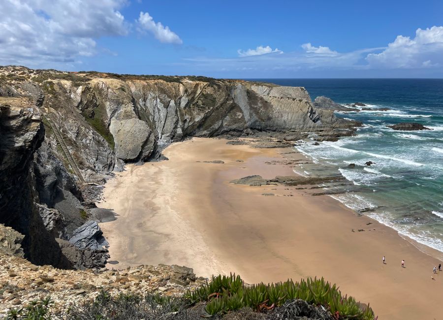 Beautiful view of Carvalhal Beach in Alentejo with cliffs and Atlantic Ocean waves.