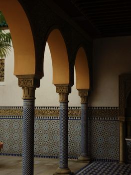Intricate moorish arches and tile patterns create a peaceful architectural scene.