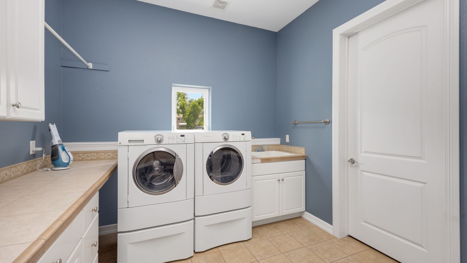 A clean, efficient laundry and utility room — heat pump water heaters need air space like this around them