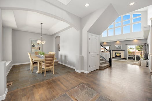 Bright, spacious open-concept dining and living room with modern design and fireplace.